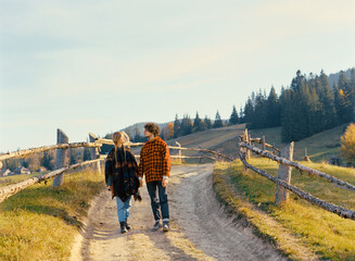 Woman and man in mountains in autumn