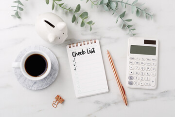 Financial planning checklist concept with calculator and piggy bank