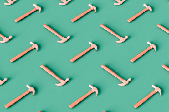 a pattern of Pink hammers on a green background