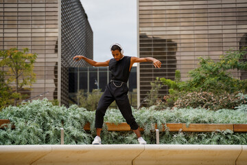 Stylish man dancing in front of office building