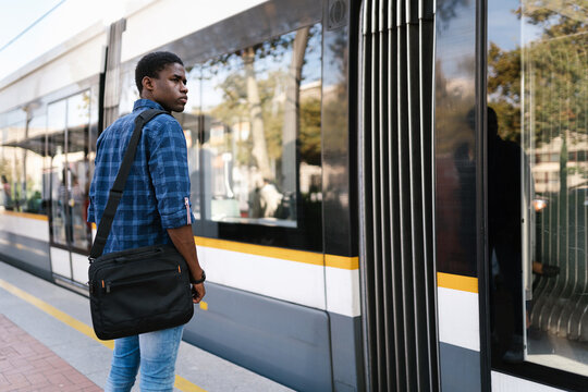 Student waiting for commercial transport on street