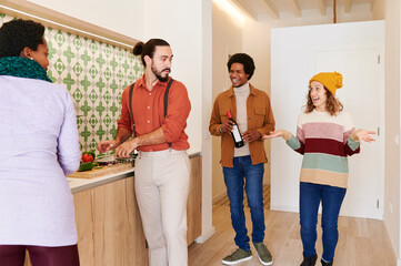 Smiling couple bring wine to a dinner