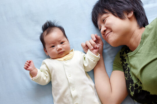 Closeup of newborn Asian baby and mom