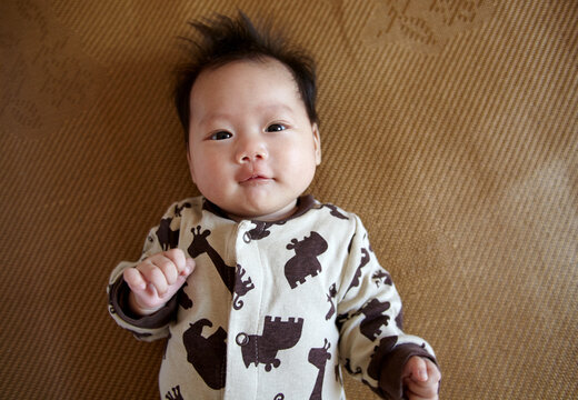 Closeup of Asian newborn baby making funny expressions