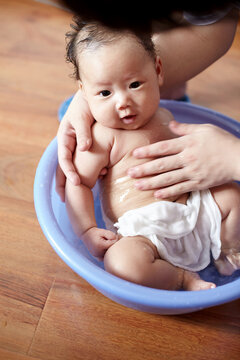 Closeup of Asian newborn baby in the bath