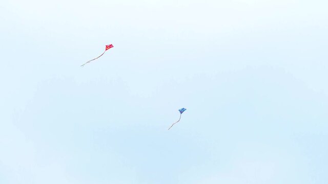 Kites flying in a cloudy sky.