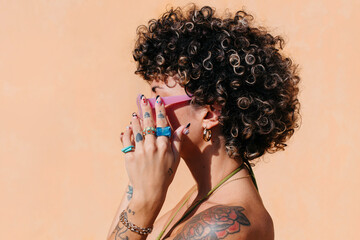 Cool woman with curly hair & nail art