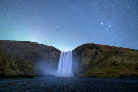 Skogafoss waterfall at night.