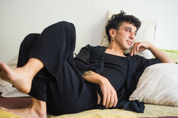 Beautiful queer person relaxing at home