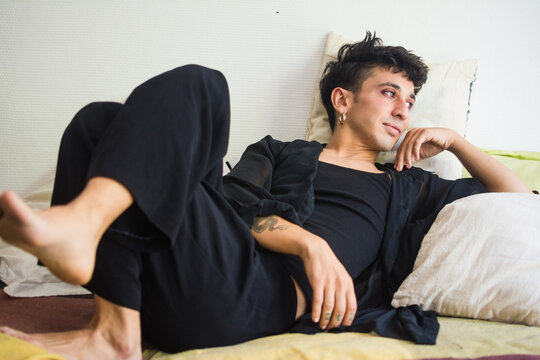 Beautiful queer person relaxing at home