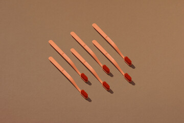 A row of toothbrushes on a brown background