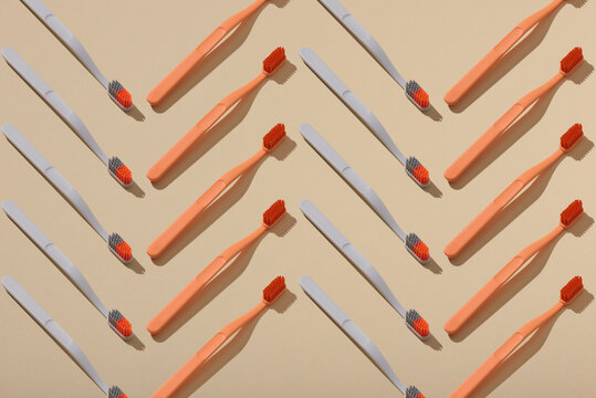 Trendy seamless pattern of toothbrushes on light background