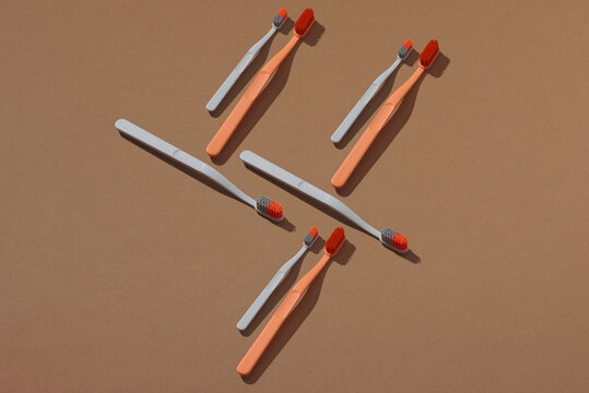 Tooth brushes on brown background