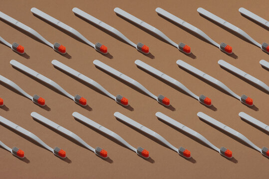 Toothbrush minimal pattern on brown background.