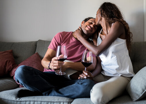 Multiracial couple kissing during date