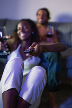 Positive diverse couple watching TV