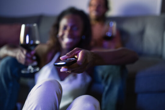 Positive diverse couple watching TV