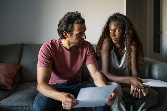 Diverse couple with debts at home