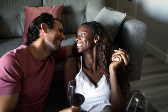 Multiracial couple hugging during date