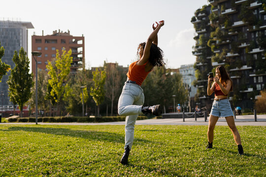 Woman filming her friend dancing