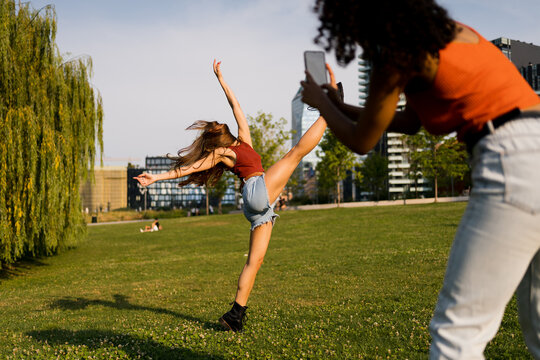 Woman filming her friend dancing