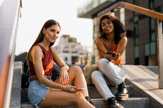 Women sitting outdoor and looking at the camera