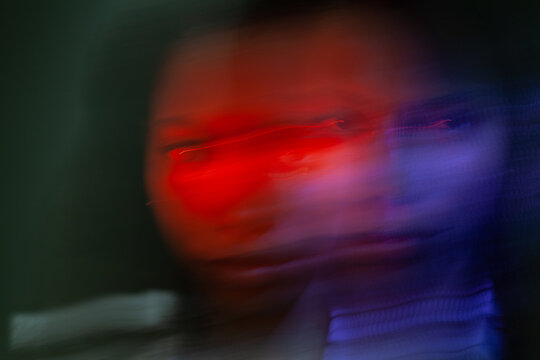 female portrait with blur in neon light