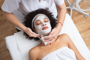 Skin Care Therapist Doing A Face Mask Treatment 