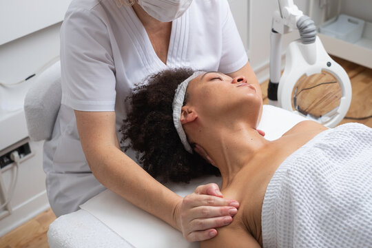 Anonymous Therapist Massaging Woman's Shoulders