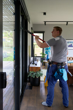 Window cleaner wiping windows