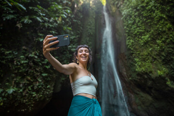 Female tourist taking selfie in jungle