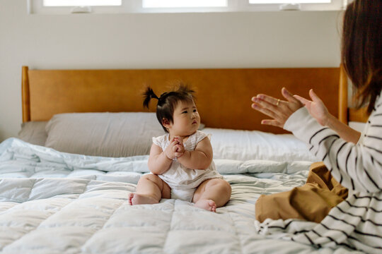 Mom And Asian Clapping Hands On Bed