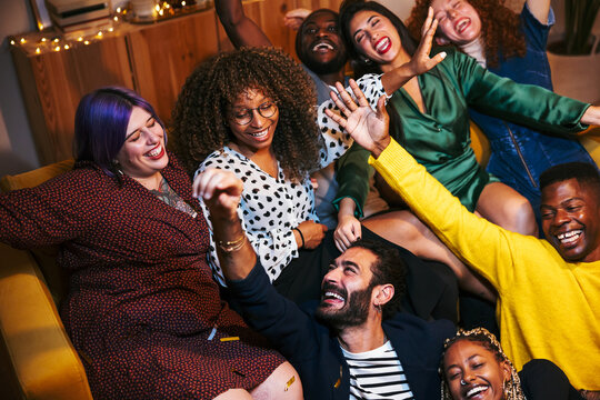 Group of friends laughing during party