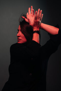 attractive dancing woman lit by red light