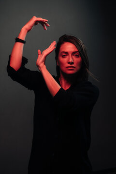 red light portrait of a beautiful dancing woman 