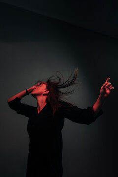 free dancing woman lit by red light