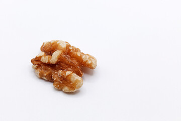 a peeled walnut on a white background