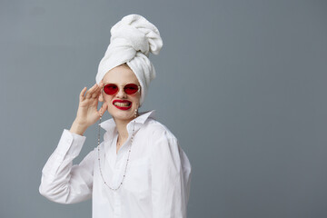 fashionable woman red glasses towel on head makeup isolated background