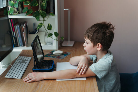 Young Schoolboy Studies From Home.