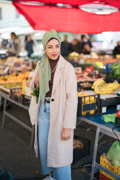 Young Muslim woman on market