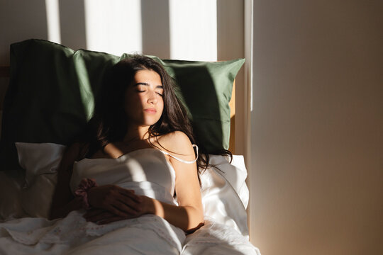 Brunette girl asleep in bed