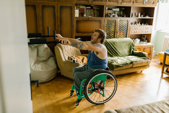 Man In A Wheelchair Preparing For A Home Training