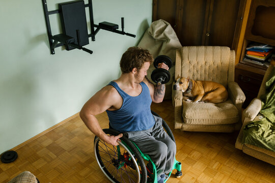 Man In A Wheelchair Working Out At Home