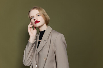 fashionable woman with red lips holds hand near face isolated background