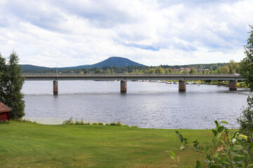 Bridge over Ljusnan river in Jarvso with Jarvsoklacken in the background