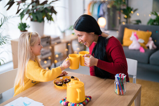 Girl and woman comparing hot drinks