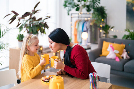 Girl and woman comparing hot drinks