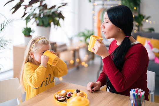 Nanny and girl drinking hot chocolate