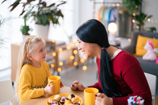 Nanny and girl drinking hot chocolate