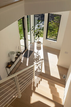 Elegant Modern Stairway in foyer with front door 